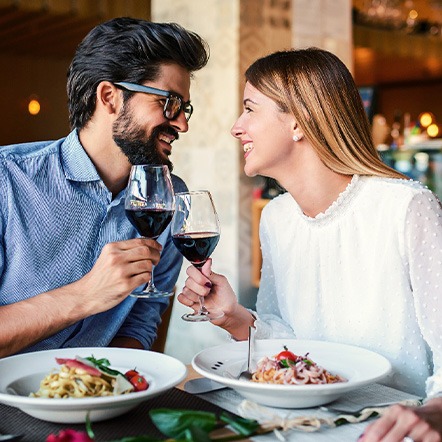 Couple smiling at each other on date in restaurant