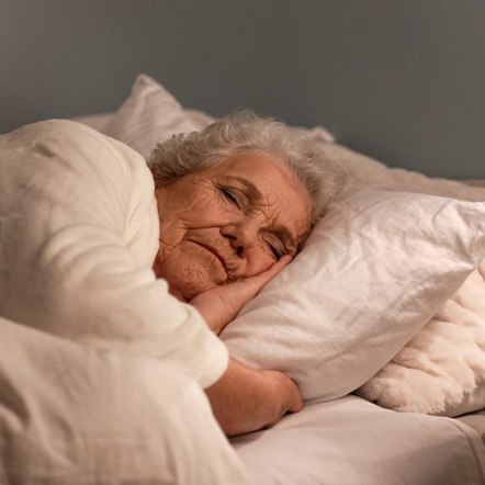 Woman lying in a cozy bed ready for sleep