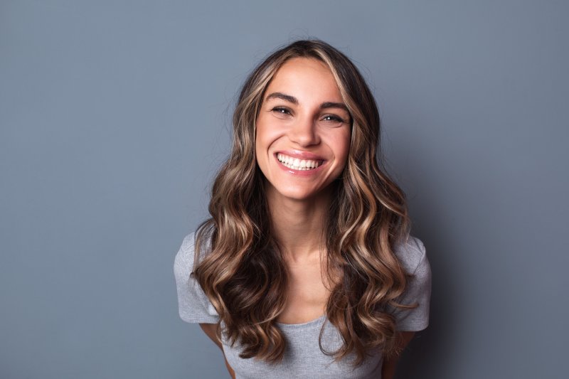 patient smiling after getting veneers